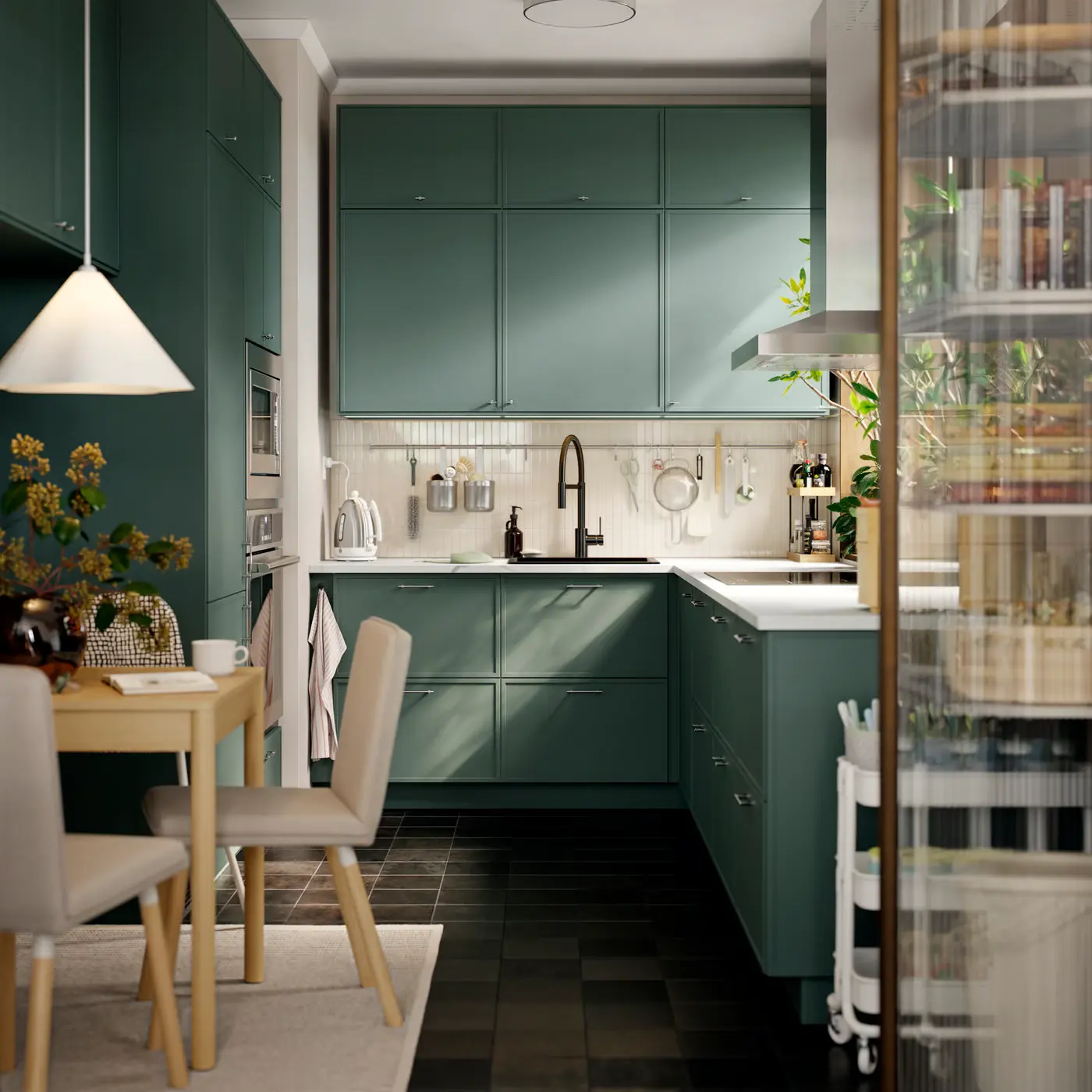 Sunlit kitchen with deep green cabinetry, white countertops, and a dining nook